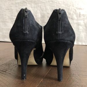 Black suede pumps with four-inch heel.